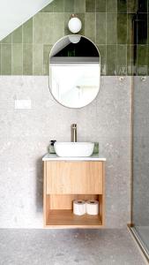 a bathroom with a sink and a mirror at Koło Wody - dom dla 6 osób in Sadków