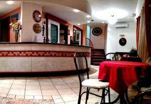 a restaurant with a counter with a table and chairs at Hotel ristorante cavallino in Cesenatico