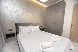 a bedroom with a bed with two towels on it at Room12 in Stavros