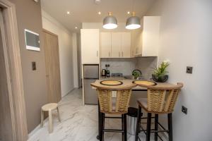 a kitchen with a table and chairs in a room at Room12 in Stavros