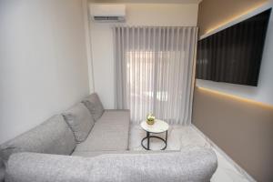 a living room with a couch and a table at Room12 in Stavros
