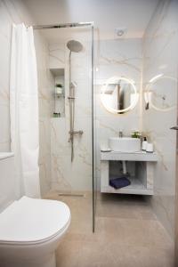 a bathroom with a shower and a toilet and a sink at Room12 in Stavros +38 photos