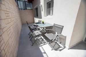 a patio with a table and chairs on a building at Room12 in Stavros