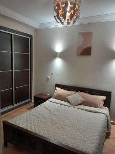 a bedroom with a large bed and a chandelier at Riviera Beach in Cabo Negro +29 photos