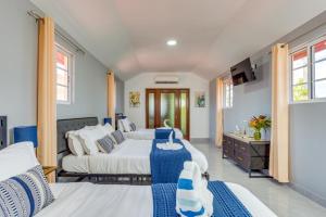 two beds in a room with blue and white at Hill Garden Boutique Resort in San Ignacio