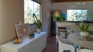 a kitchen with a table and a dining room at Pousada Santa Rita in Amarantina +21 photos