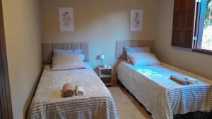 a bedroom with two beds with shoes on them at Pousada Santa Rita in Amarantina