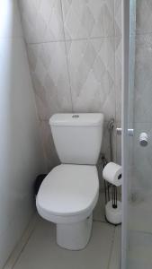 a bathroom with a white toilet in a room at Pousada Santa Rita in Amarantina