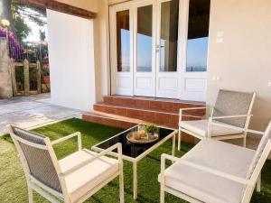 two chairs and a coffee table on a porch with a view at Affaccio degli Dei in Drapia