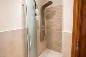 a shower with a glass door in a bathroom at Affaccio degli Dei in Drapia