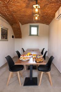 a dining room with a table with food on it at Cascina Bella - Piozzo in Piozzo
