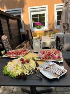 a table with three plates of food on it at Penzion Richnava in Štiavnické Bane