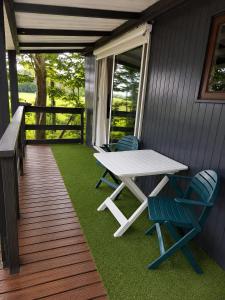 a table and chairs on the porch of a house at RB&B in the NOP in Bant