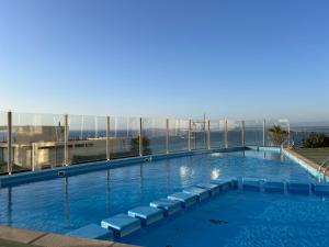 a large swimming pool on top of a building at Oceana Suites Costa Montemar in Concón +28 photos