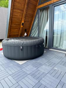 a large tire sitting in front of a house at Theforestheaven in Brđani +3 photos