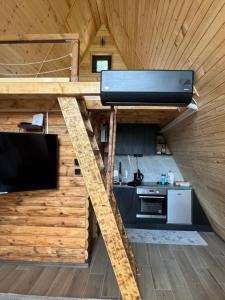 a loft bed in a tiny house at Theforestheaven in Brđani