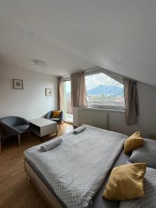 a bedroom with a bed and a large window at Above Apartments in Liptovský Mikuláš +57 photos
