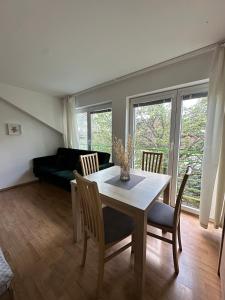a living room with a table and chairs and a couch at Above Apartments in Liptovský Mikuláš