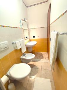 a bathroom with a toilet and a sink at B&B Profumo di Zagara in Taormina