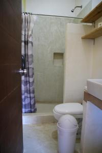 a bathroom with a toilet and a sink and a shower at Patio Canarias Chacala Suites Pet-Friendly in Chacala +51 photos