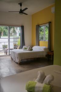 a hotel room with two beds and a balcony at Patio Canarias Chacala Suites Pet-Friendly in Chacala