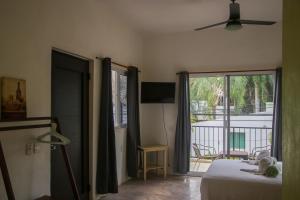 a bedroom with a bed and a view of a balcony at Patio Canarias Chacala Suites Pet-Friendly in Chacala