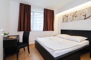 a hotel room with a bed and a desk and a desk at Balino C1 in Balatonlelle
