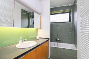 a bathroom with a sink and a shower and a tub at Balino C1 in Balatonlelle +9 photos