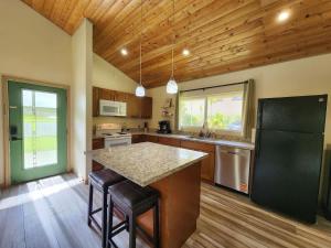 a kitchen with a black refrigerator and a counter at Family Friendly Oasis- Firepit-Puzzles-Breakfast in Mountain View