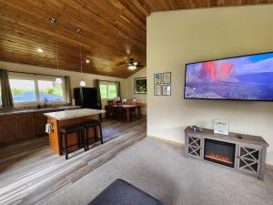 a living room with a fireplace and a tv on the wall at Family Friendly Oasis- Firepit-Puzzles-Breakfast in Mountain View +24 photos