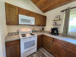 a kitchen with a white stove and a microwave at Family Friendly Oasis- Firepit-Puzzles-Breakfast in Mountain View