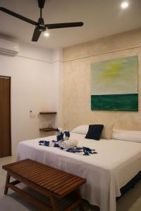 a bedroom with a large bed with a ceiling fan at Casa Maracuyá Chacala in Chacala