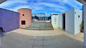 a patio with a staircase and a brick building at Vacanze - Neo in Maceió