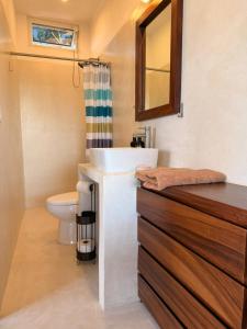a bathroom with a sink and a toilet at Casa Maracuyá Chacala in Chacala