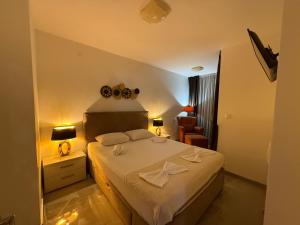a bedroom with a bed and a chair in a room at Lux Apartment Vidovic II in Rafailovici +43 photos