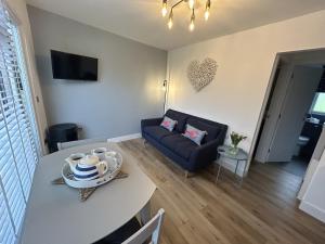 a living room with a couch and a table at SeaStar Dartmouth in Dartmouth