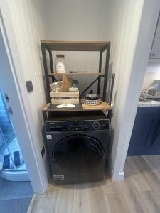 a laundry room with a washer and dryer in a room at SeaStar Dartmouth in Dartmouth +3 photos