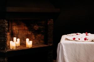 two candles sitting on a table next to a fireplace at Riad Eucalyptus, hôtel de charme Essaouira in Essaouira