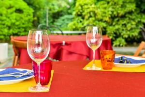 two wine glasses sitting on top of a table at Cascina Folletto in Novi Ligure