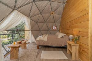 a bedroom with a bed in a triangular shaped room at Cascada de las Animas in San Alfonso