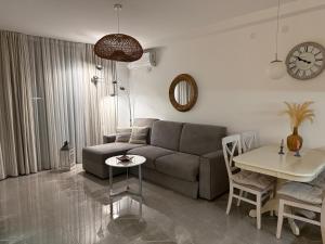 a living room with a couch and a table at Lux Apartment Vidovic II in Rafailovici