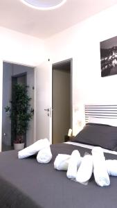 a bedroom with a bed with four pillows on it at Urban Rifugio - Camera privata con bagno vicino EUR in Rome +28 photos