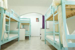 a room with blue bunk beds in a dorm room at Dub Hostel Saranda in Sarandë