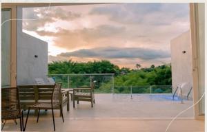 a view from the balcony of a house with a table and chairs at Finca Hotel la Manuela in Armenia
