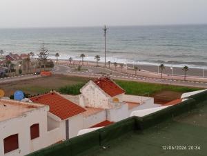 a view of the ocean from the roof of a building at B nadir in Tétouan
