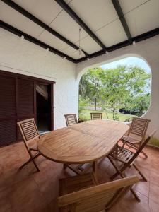 a wooden table and chairs on a patio at Boustan homes in Cabo Negro