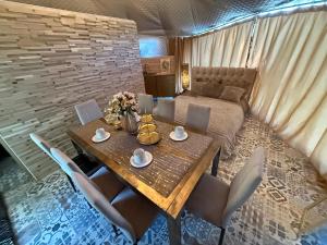 a room with a table and chairs and a bed at Couple Luxury Villa in Apšuciems