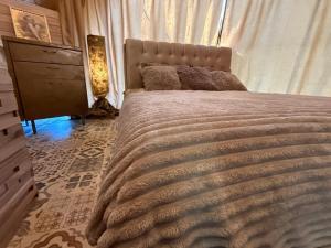 a bedroom with a large bed and a dresser at Couple Luxury Villa in Apšuciems