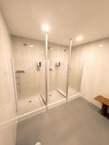 a bathroom with a walk in shower and a walk in shower at As Baladas Hostel in Barro +15 photos