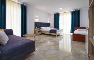 a living room with two beds and a couch at Hotel Vathi in Ksamil +94 photos